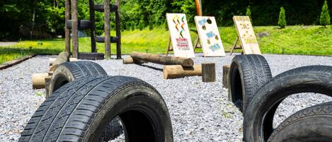 Un parque infantil con obstáculos de neumáticos y estructuras de madera.