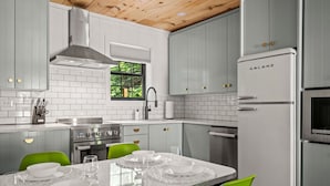 A modern kitchen with white cabinets, a stainless steel range, and a Galanz refrigerator. - 2bdrm Cabin 3 Gburg Pet-friendly Firepit Games (Gatlinburg)