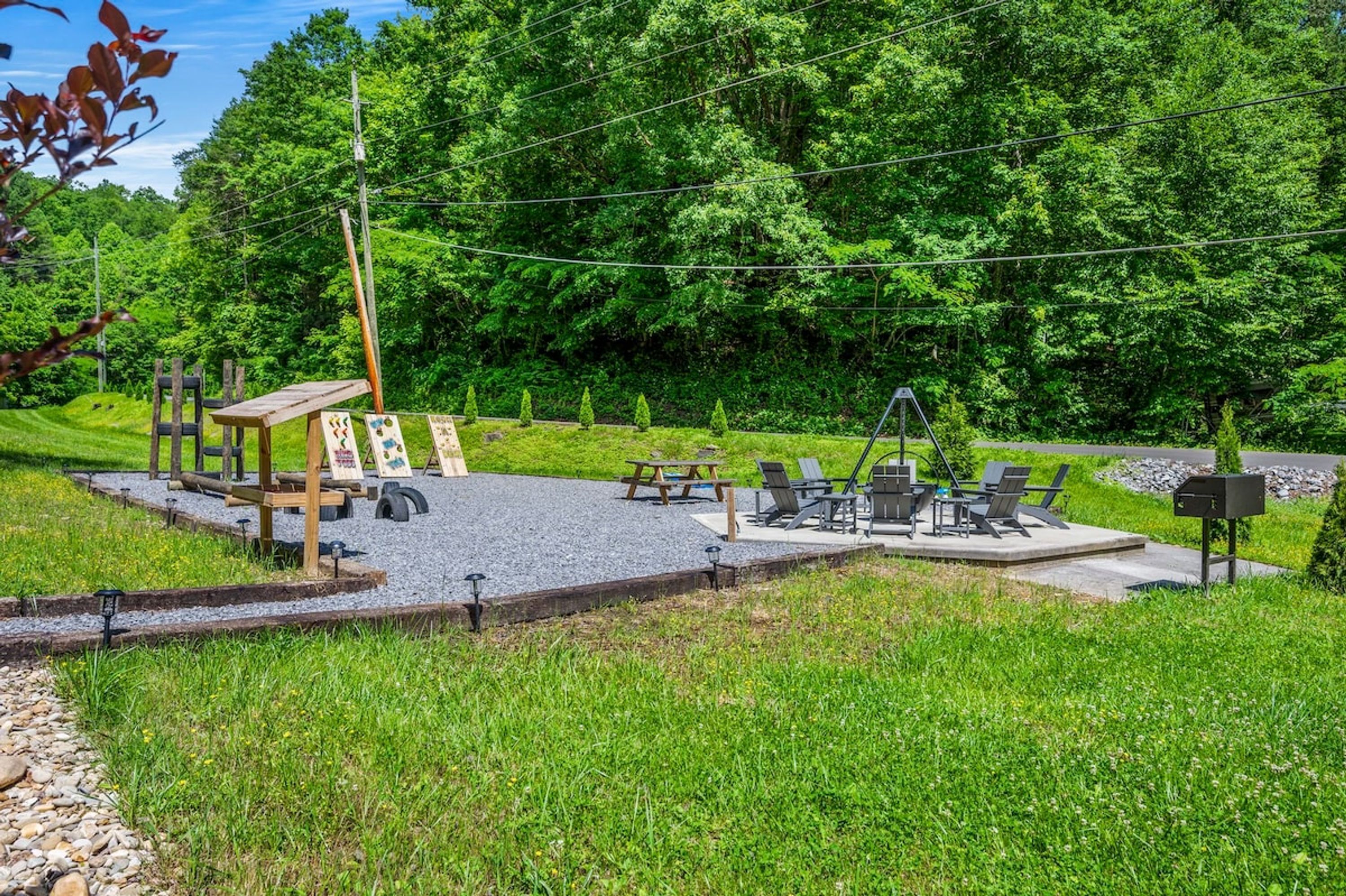 A park with outdoor exercise equipment, picnic tables, and a wooden structure.