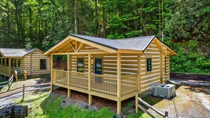 A cabin with a balcony, a small porch, and a door. - 2bdrm Cabin 2 Gburg Pet Friendly Fire Pit Game (Gatlinburg)
