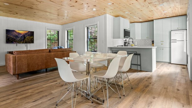 A modern kitchen with white cabinets and a stainless steel refrigerator.