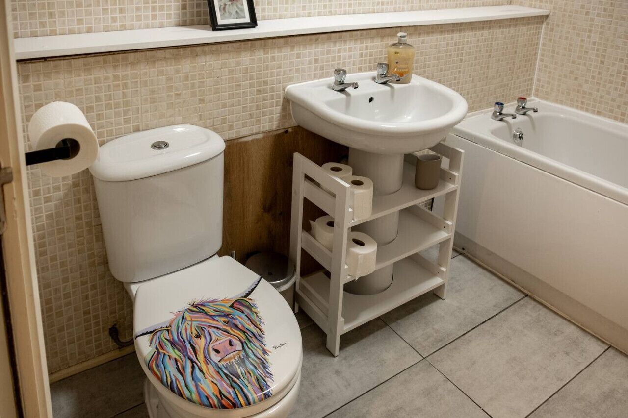 Un baño con inodoro, lavamanos y bañera.