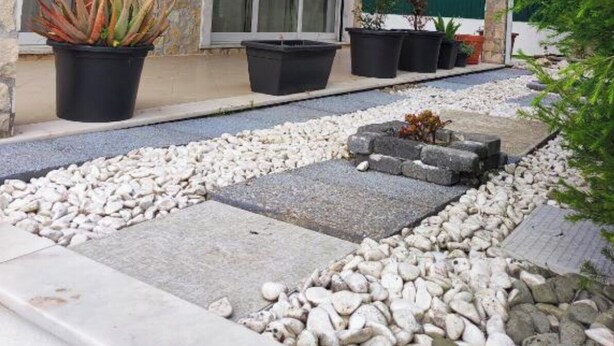 A stone building with large windows and potted plants. - Welcome to SINTRA HOME, a haven between green hills and the blue Atlantic. (São João das Lampas)