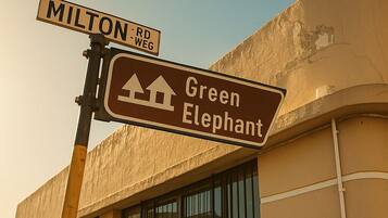 Street signs for 'Milton Rd' and 'Green Elephant'.