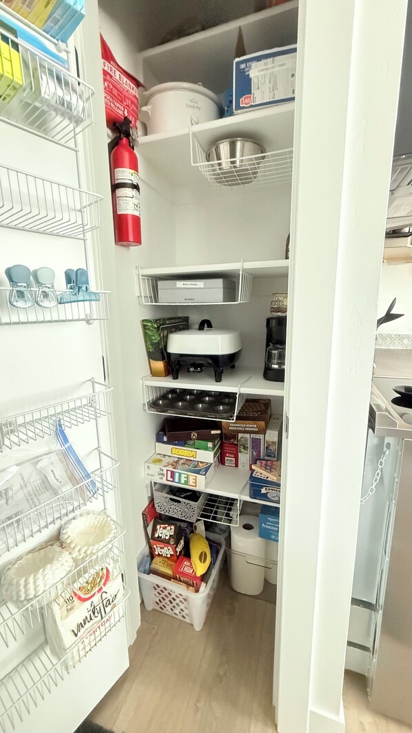 A well-organized pantry with shelves, a fire extinguisher, and various food items. - Quiet secluded neighborhood quick freeway access canyons shopping entertainment (Draper)