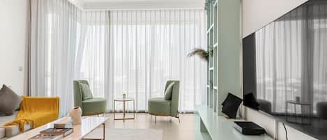 Luxury Apartment, City View | Living area | 52-inch flat-screen TV with cable channels