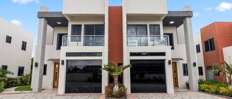 A modern building with a symmetrical facade, large windows, and a central entrance.