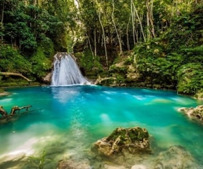 A waterfall in a forested area with clear blue water. - Private Pool Draxhall Gated Gym Tennis Full AC (St. Ann's Bay)