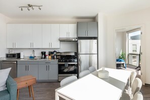 Departamento clásico, vista a la ciudad | Cocina privada | Refrigerador, microondas, horno y parrilla de estufa 