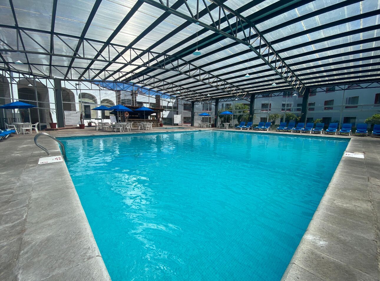 Indoor pool, open 8:00 AM to 8:00 PM, pool umbrellas, pool loungers