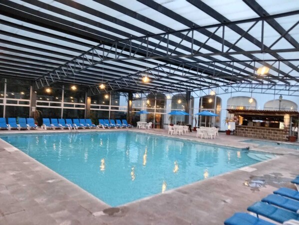 Indoor pool, open 8:00 AM to 8:00 PM, pool umbrellas, pool loungers