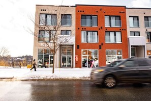 A multi-story building with numbered windows and a storefront.