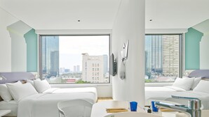 A modern hotel room with two beds, a large window with a city view, a white sink, and a chair. - Tru By Hilton Da Nang City Centre (Da Nang)