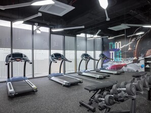 A gym with treadmills, a bench, and dumbbells. - Tru By Hilton Da Nang City Centre (Da Nang)
