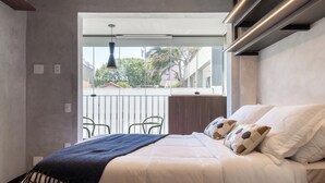 A bedroom with a bed, a window, and a view of the outside. - Akile Be Urban (Sao Paulo)