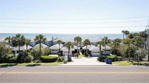 A row of modern houses with a clear view of the ocean.