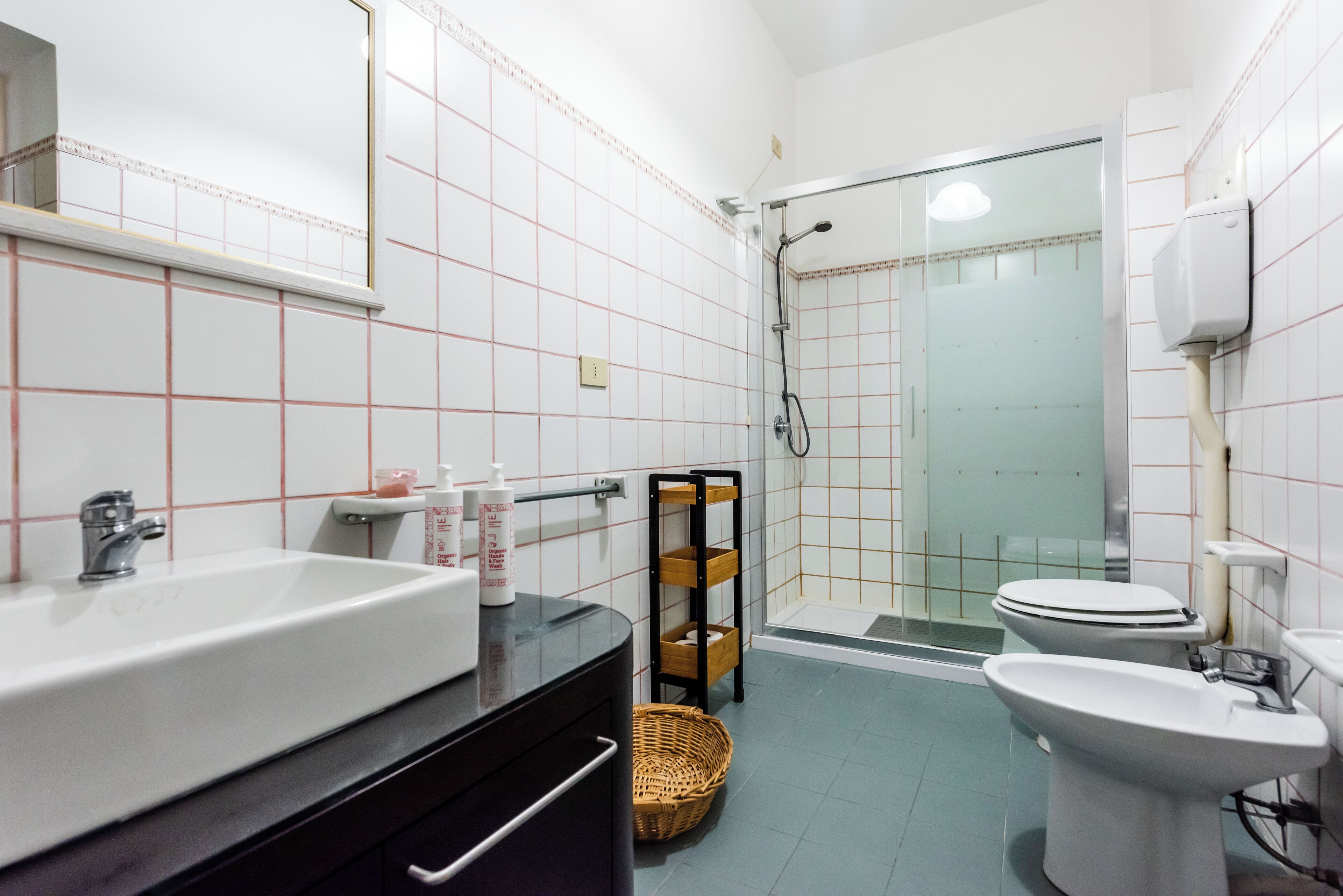 A bathroom with a sink, toilet, and shower.