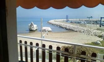Un balcón con vista a una costa rocosa y al mar.