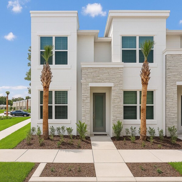 A modern two-story house with a stone facade, a front door, and two palm trees.