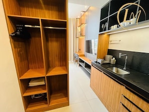 Eine moderne Küche mit Holzausstattung, einer schwarzen Arbeitsplatte und einem eingebauten Backofen.