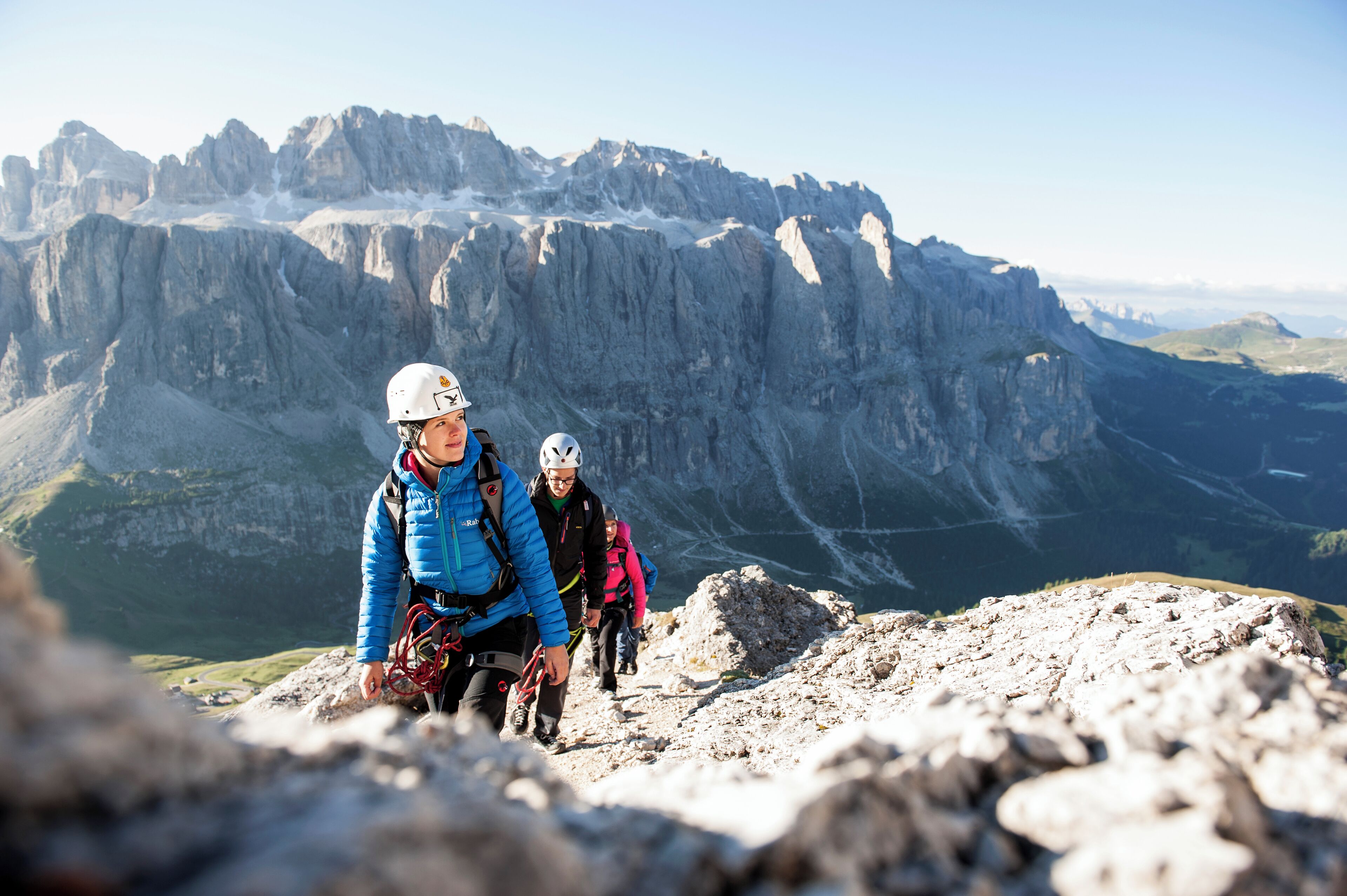 A mountain hiking trail with rocky terrain and a mountainous backdrop.
