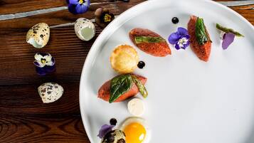A white plate with food items and decorative elements on a wooden surface.