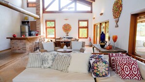 Amplia sala de estar con sofá, mesa de comedor y zona de cocina.