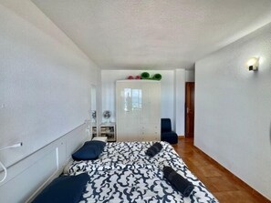 A bedroom with a bed, bedside table, and a wardrobe. - Neptuno Ocean Experince by Sydney (Puerto de Santiago)