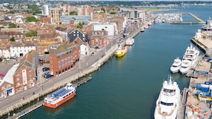 A harbor with boats, a large cruise ship, and buildings along the waterfront. - Sun-Soaked - Charming Views Overlooking the Harbour (Poole)