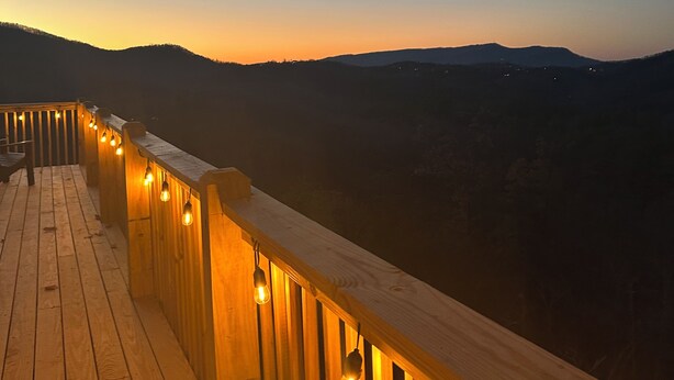 A wooden deck with string lights, overlooking a hilly landscape. - Pigeon forge Views Hot Tub Private Gatlinburg (Carolina)