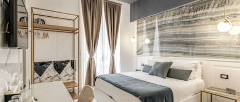 A modern bedroom with a bed, bedside table, and a large window with curtains.