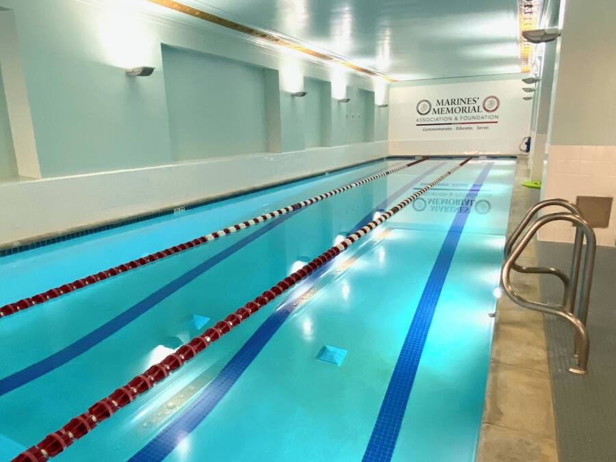 A swimming pool with lane dividers and a lifeguard chair.