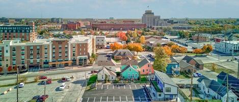 A downtown area with a parking lot, a hotel, and various buildings.