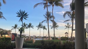 A poolside area with lounge chairs and a view of the ocean. - Hotel Sea Garden, Nuevo Vallarta, Mexico. Sleeps 4 adults & 2 children. (Nuevo Vallarta)