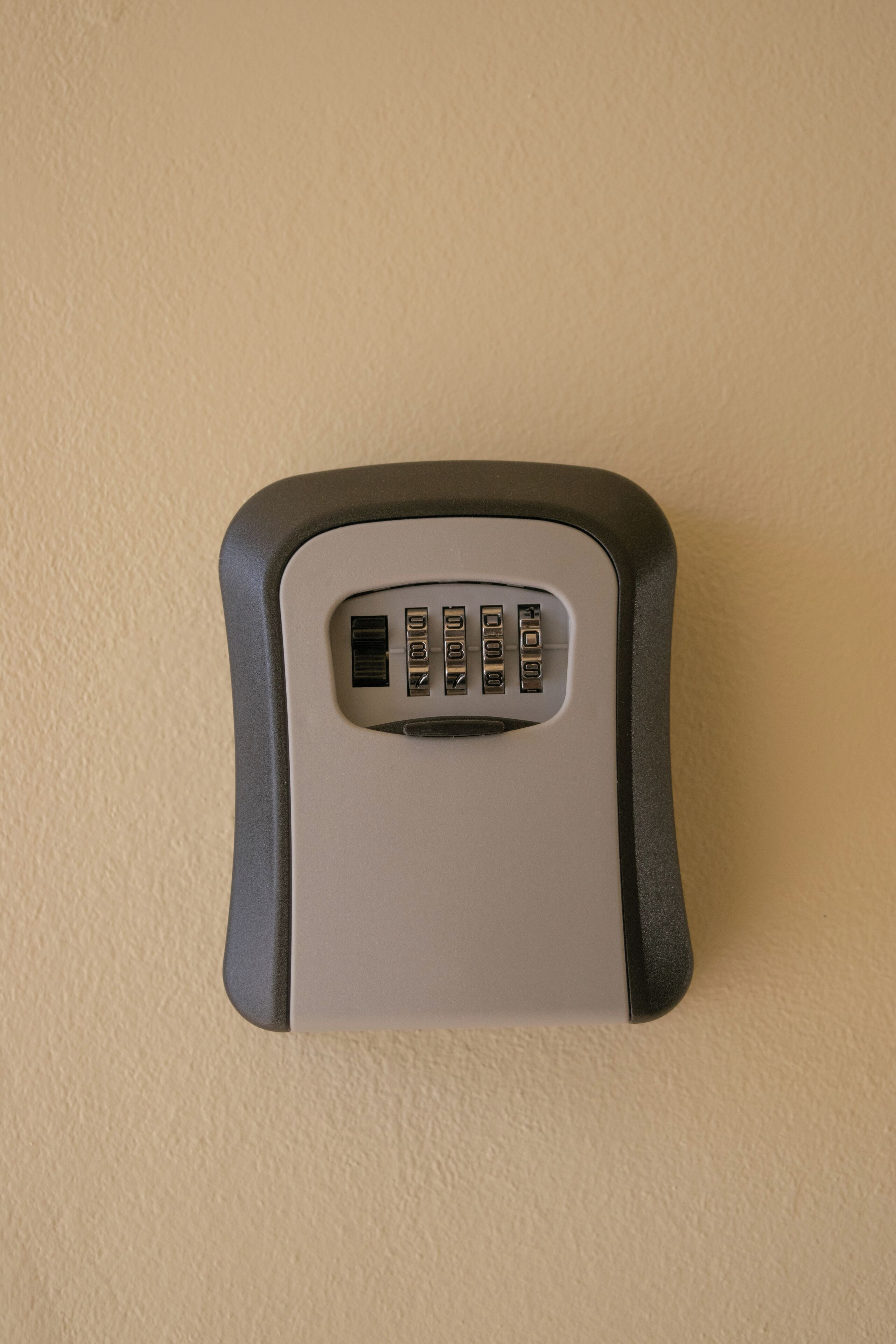 A wall-mounted electronic device with a keypad and USB ports.