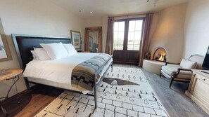 A hotel room with a bed, a desk, a chair, a television, and a window. - The Lincoln 402, 2 Bed / 2.5 Bath, Luxury Condo (Santa Fe)