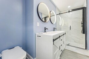 A modern bathroom with a white vanity, two sinks, and a large mirror with LED lights. - Charming newly updated home in Avalon with endless views of bay and sunset (Avalon)