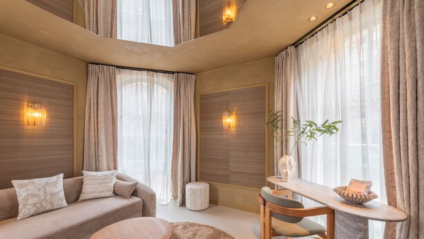 A modern living room with a sofa, a round wooden table, and a dining area. - Unique 3 floor tower apartment with AC at Westerpark (Amsterdam)