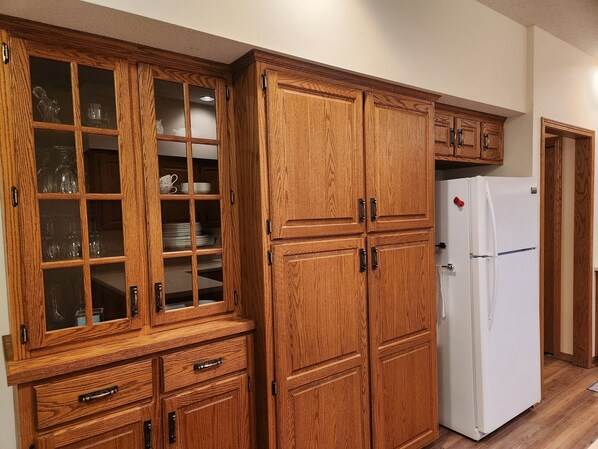 A kitchen with wooden cabinets, a white refrigerator, and a microwave. - Country Home Sleeps 6 Adults, Lg Living & Kitchen
Fire Pit, Crow River Winery (Hutchinson)