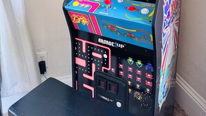 A vintage arcade machine with colorful graphics and buttons.
