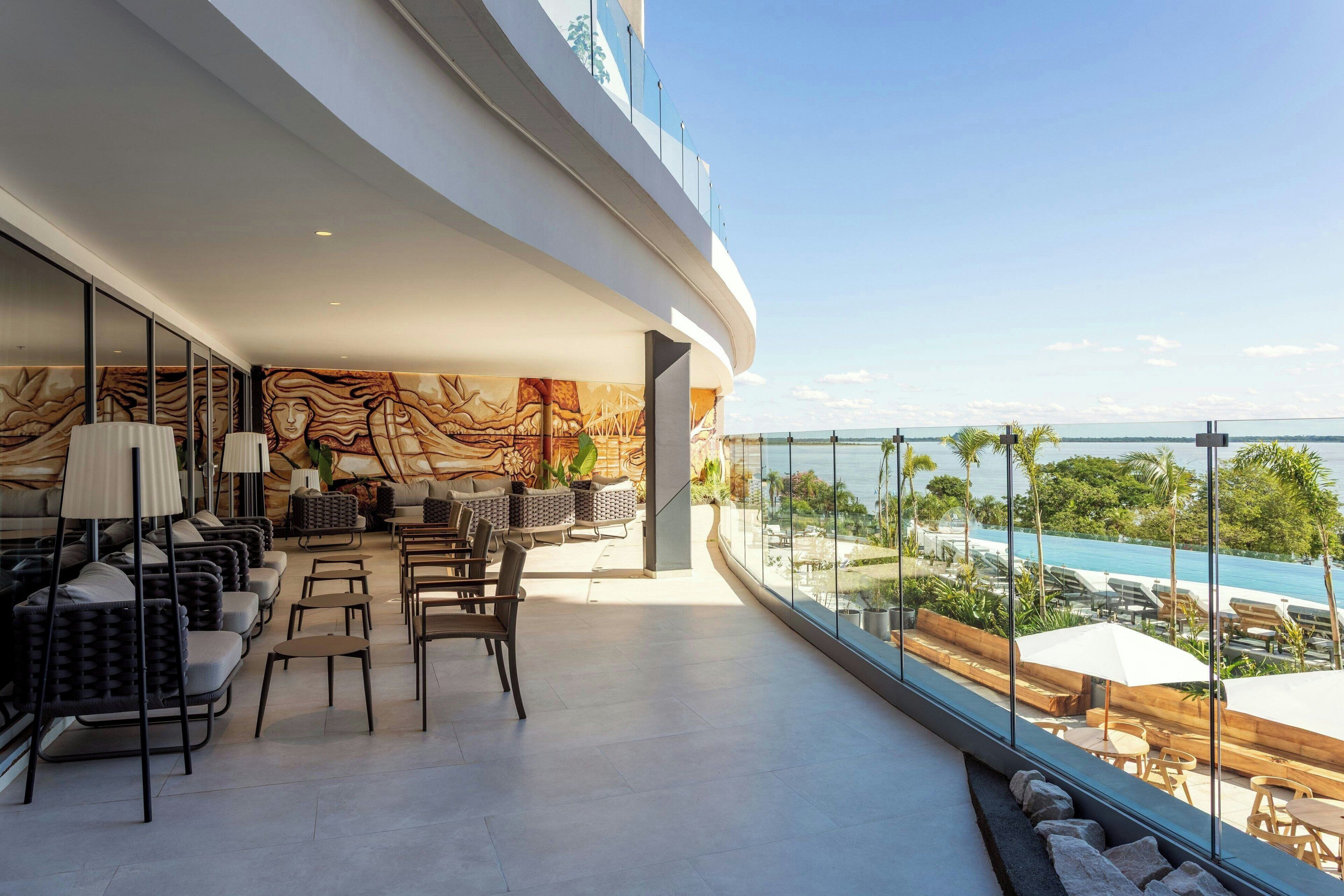 A modern lounge with seating and a view of the pool.