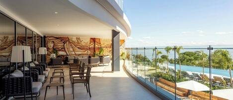 A modern lounge with seating and a view of the pool.
