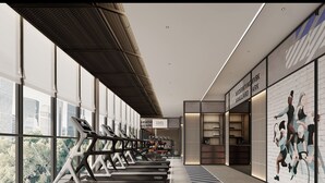 Une salle de sport moderne équipée de tapis de course, dotée de grandes fenêtres et ornée d’une fresque murale.