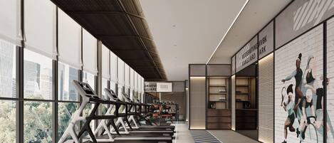 A modern gym with treadmills, large windows, and a mural on the wall.
