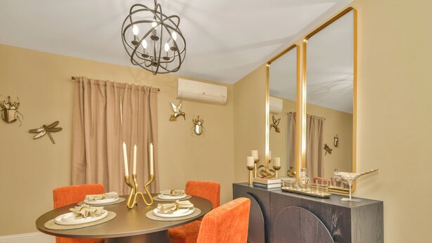 A dining area with a round table, orange chairs, and a chandelier. - NEW! Upscale Private 3 Bed, Free Parking, W&D, Near MBTA, Backyard (Boston)