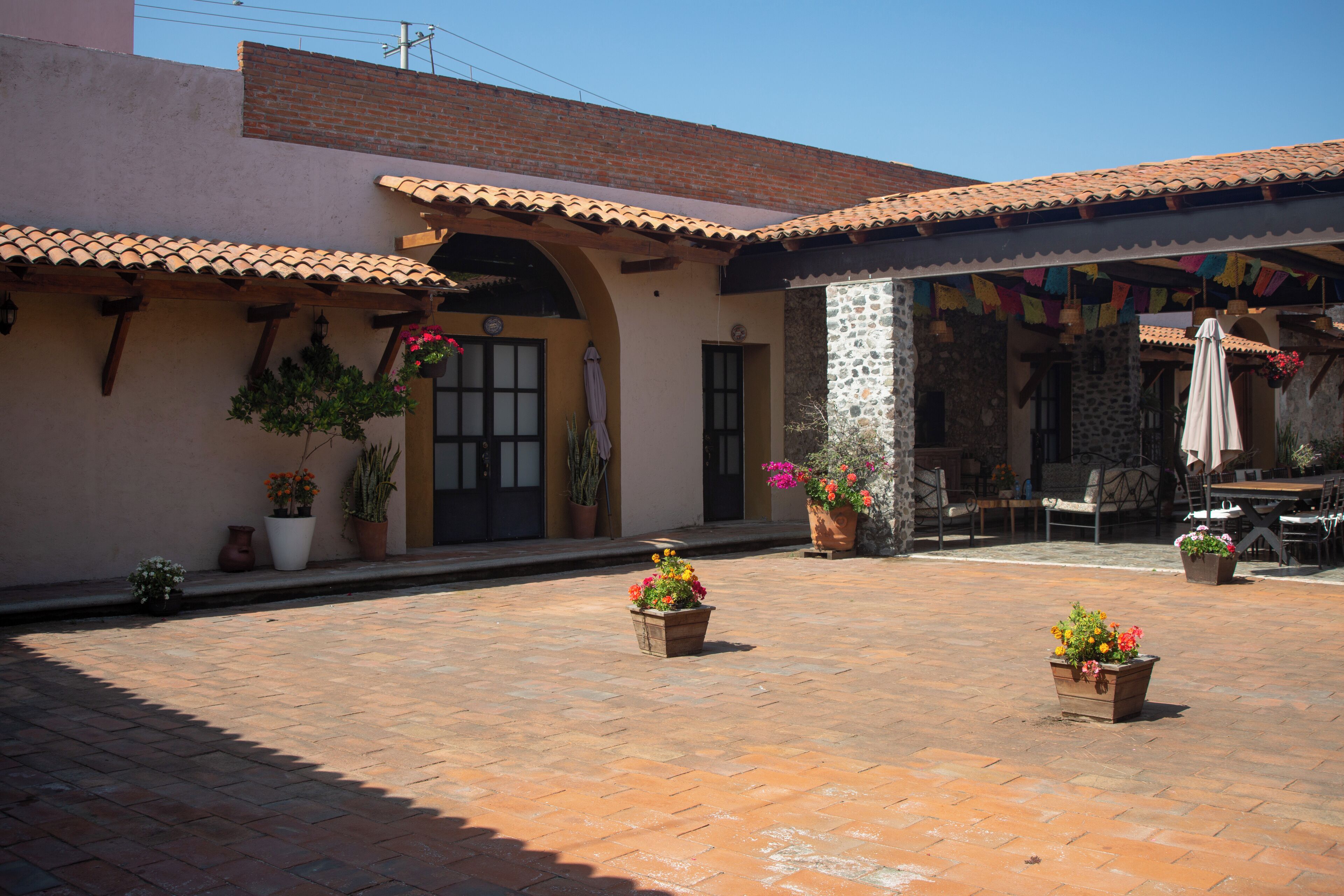 A courtyard with potted plants and outdoor seating.