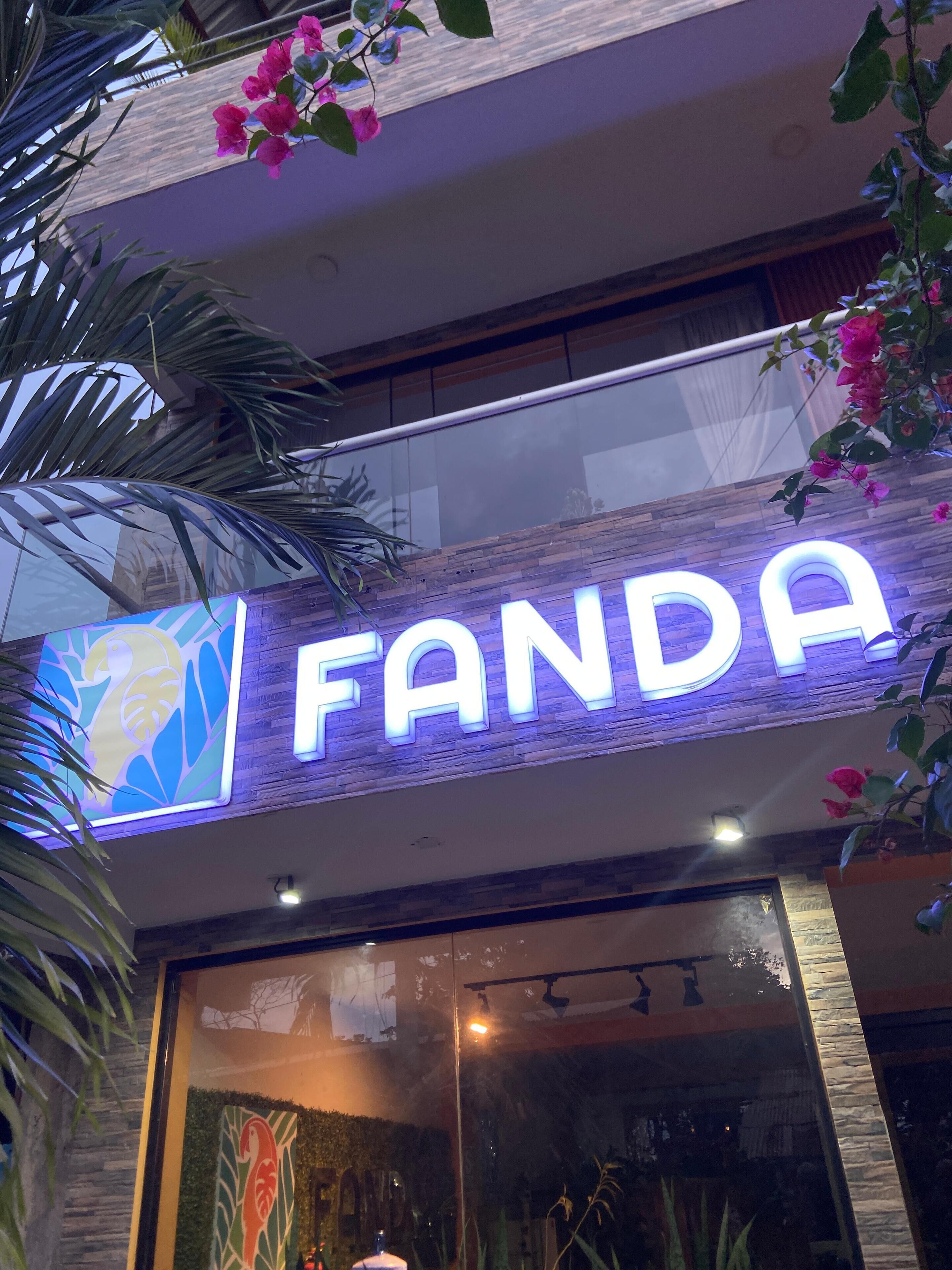 A building with a sign that reads "FANDA" in illuminated letters.