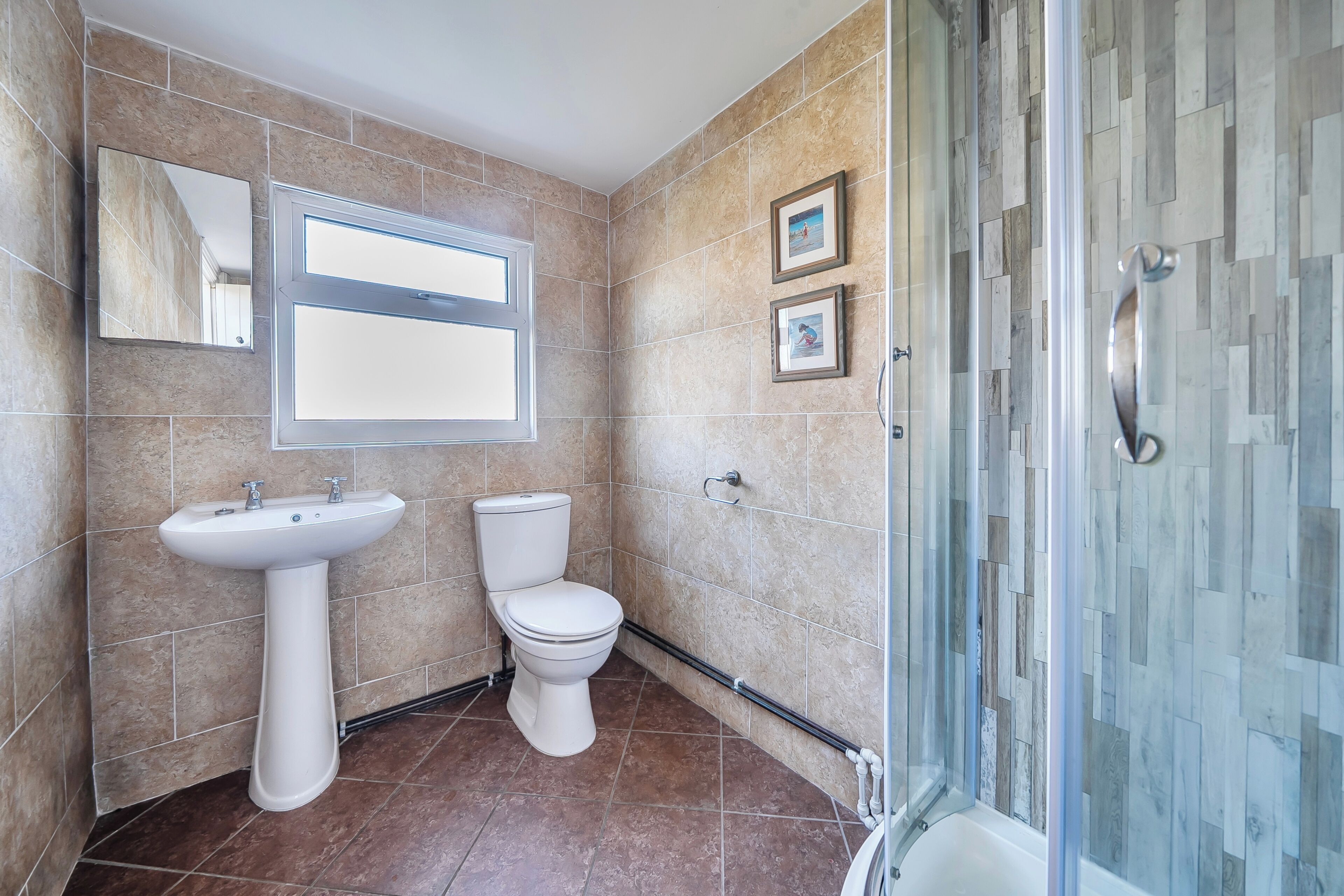 A bathroom with a sink, toilet, and shower.