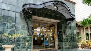 The entrance to The Royal Garden with a marble facade and a sign above the doors.