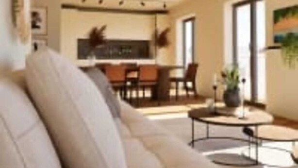 A modern living room with a sofa, a coffee table, and a dining area in the background. - Le Galli (Sanary-sur-Mer)